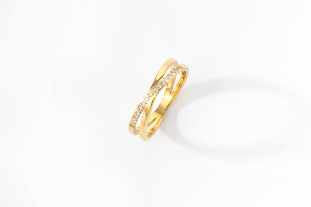 Crossing Wave Ring in gold tone, flat lay detail
