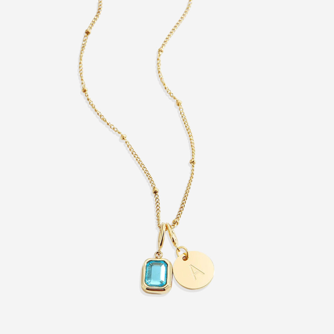 Collana con baguette, pietra portafortuna e iniziale