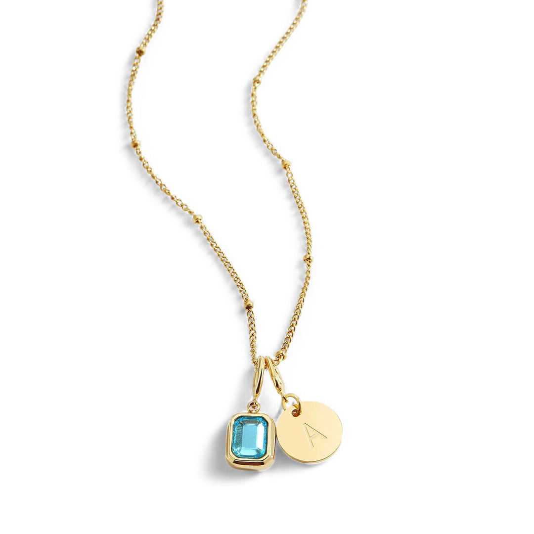 Collana con baguette, pietra portafortuna e iniziale
