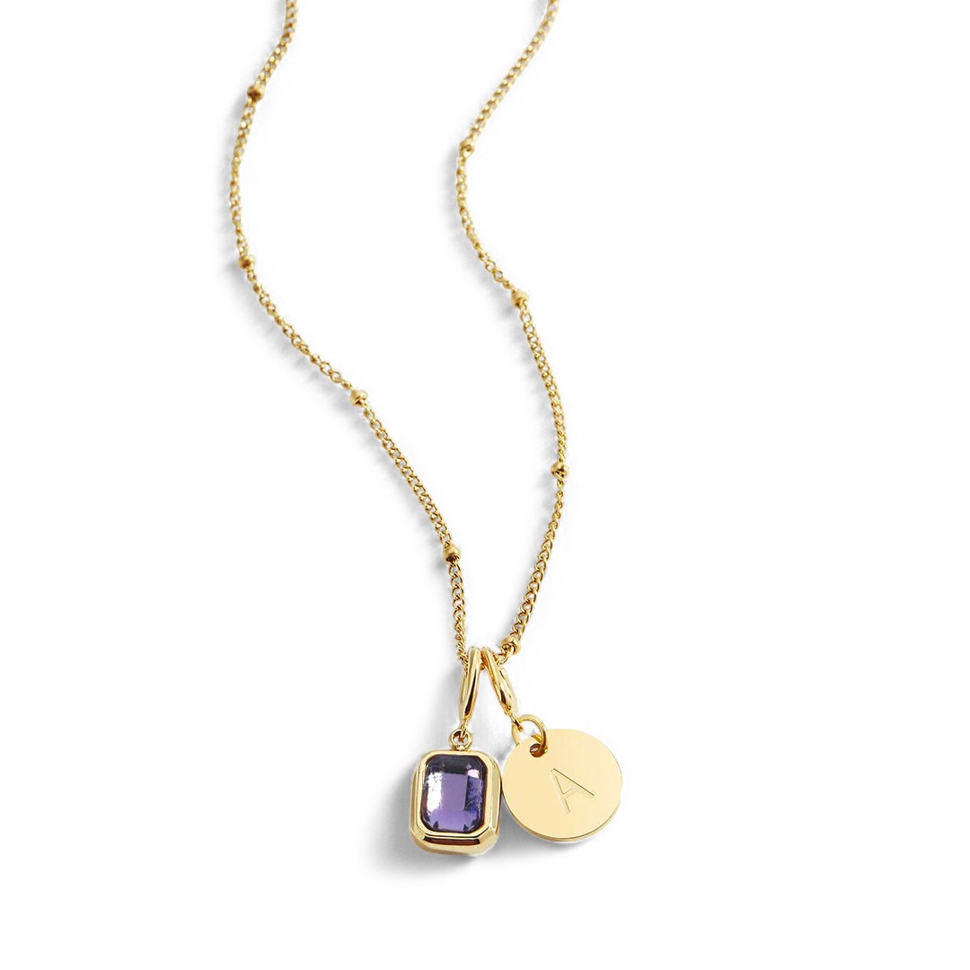 Collana con baguette, pietra portafortuna e iniziale