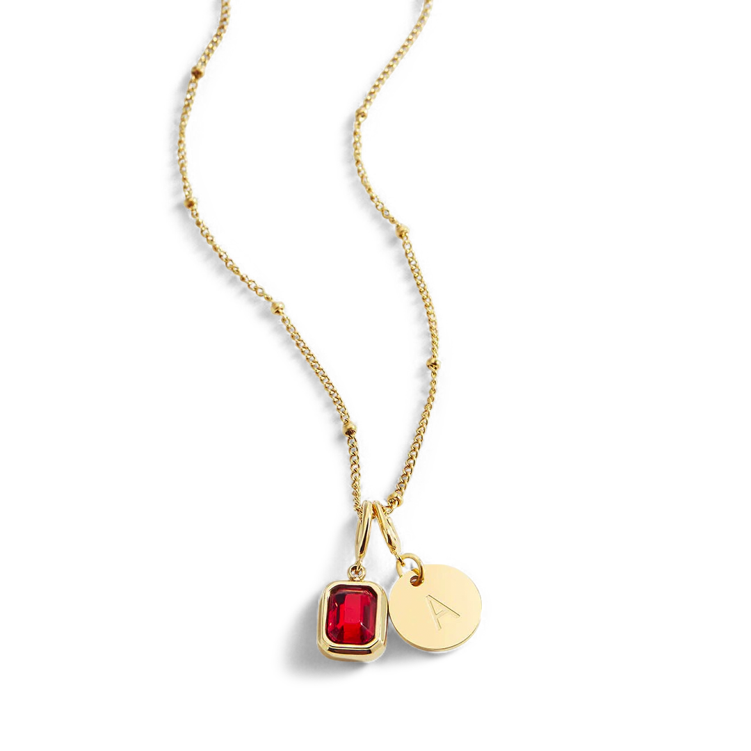 Collana con baguette, pietra portafortuna e iniziale