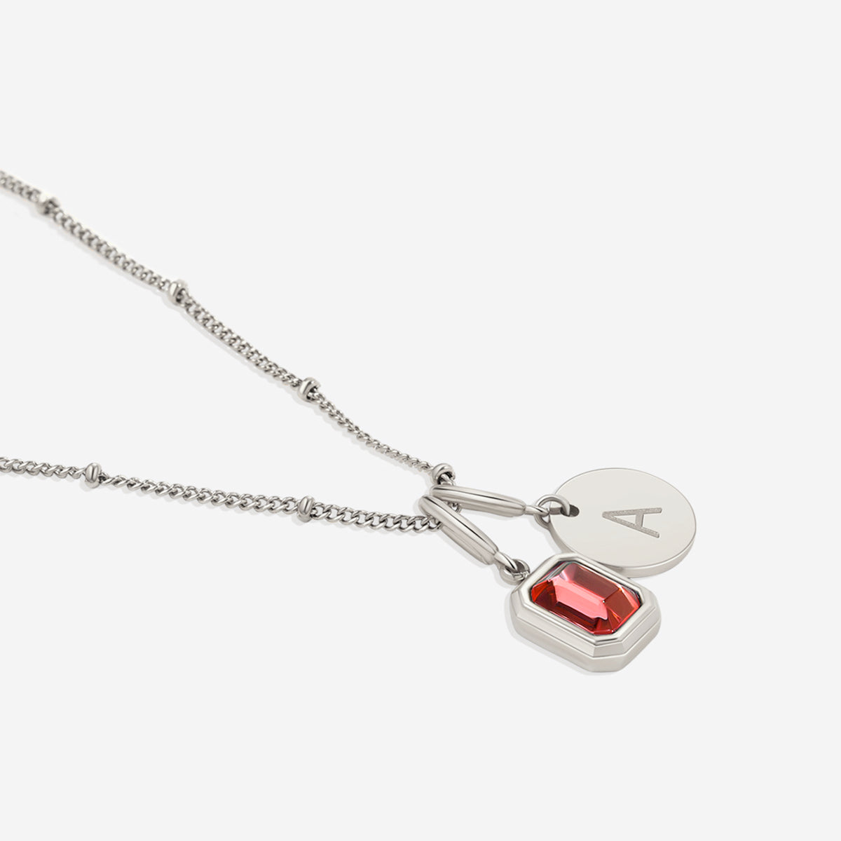 Collana con baguette, pietra portafortuna e iniziale