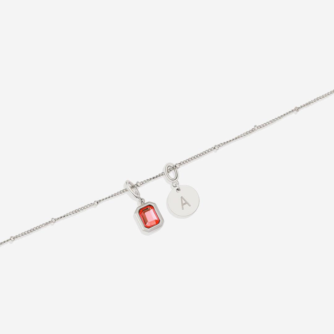 Collana con baguette, pietra portafortuna e iniziale