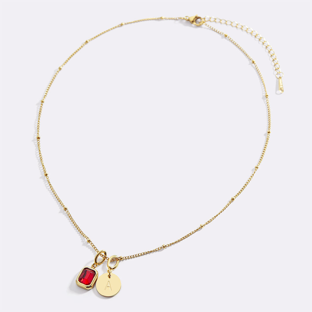 Collana con baguette, pietra portafortuna e iniziale