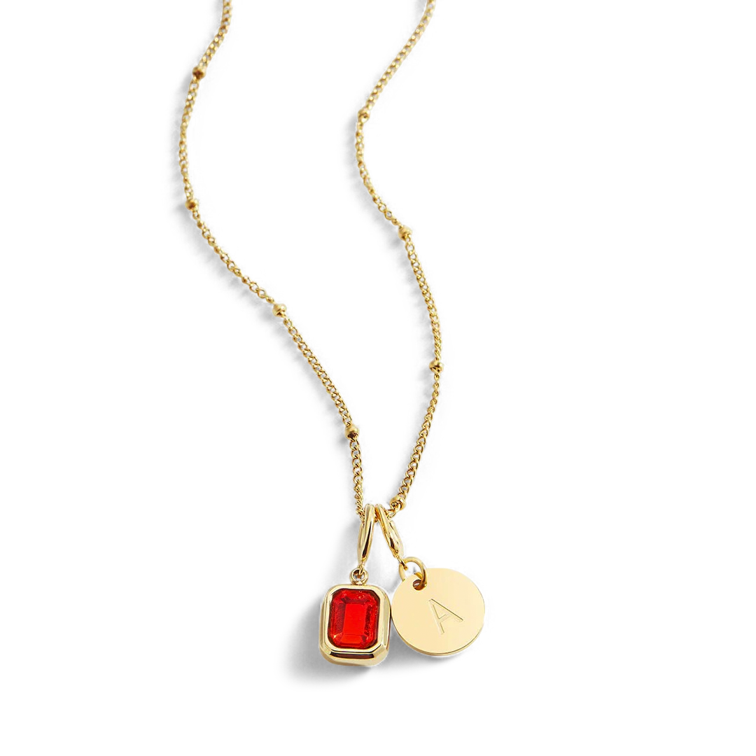 Collana con baguette, pietra portafortuna e iniziale