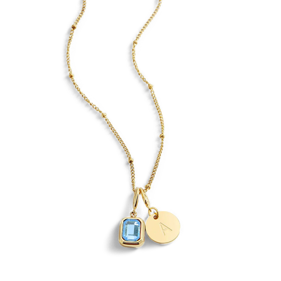 Collana con baguette, pietra portafortuna e iniziale