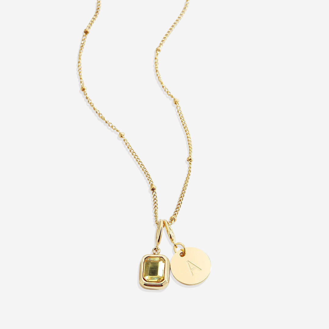Collana con baguette, pietra portafortuna e iniziale