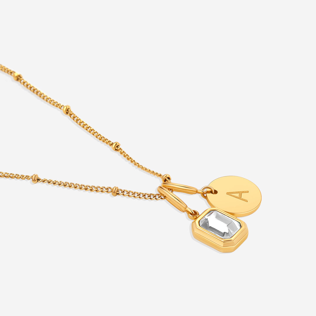 Collana con baguette, pietra portafortuna e iniziale