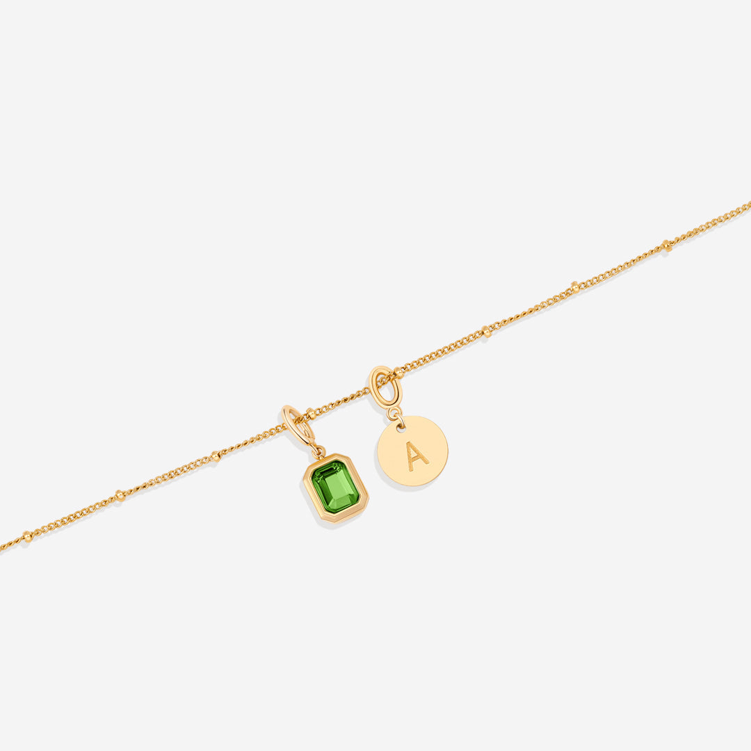 Collana con baguette, pietra portafortuna e iniziale