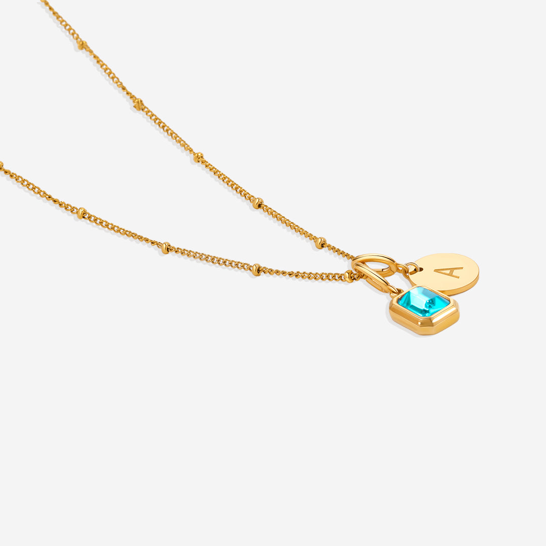 Collana con baguette, pietra portafortuna e iniziale