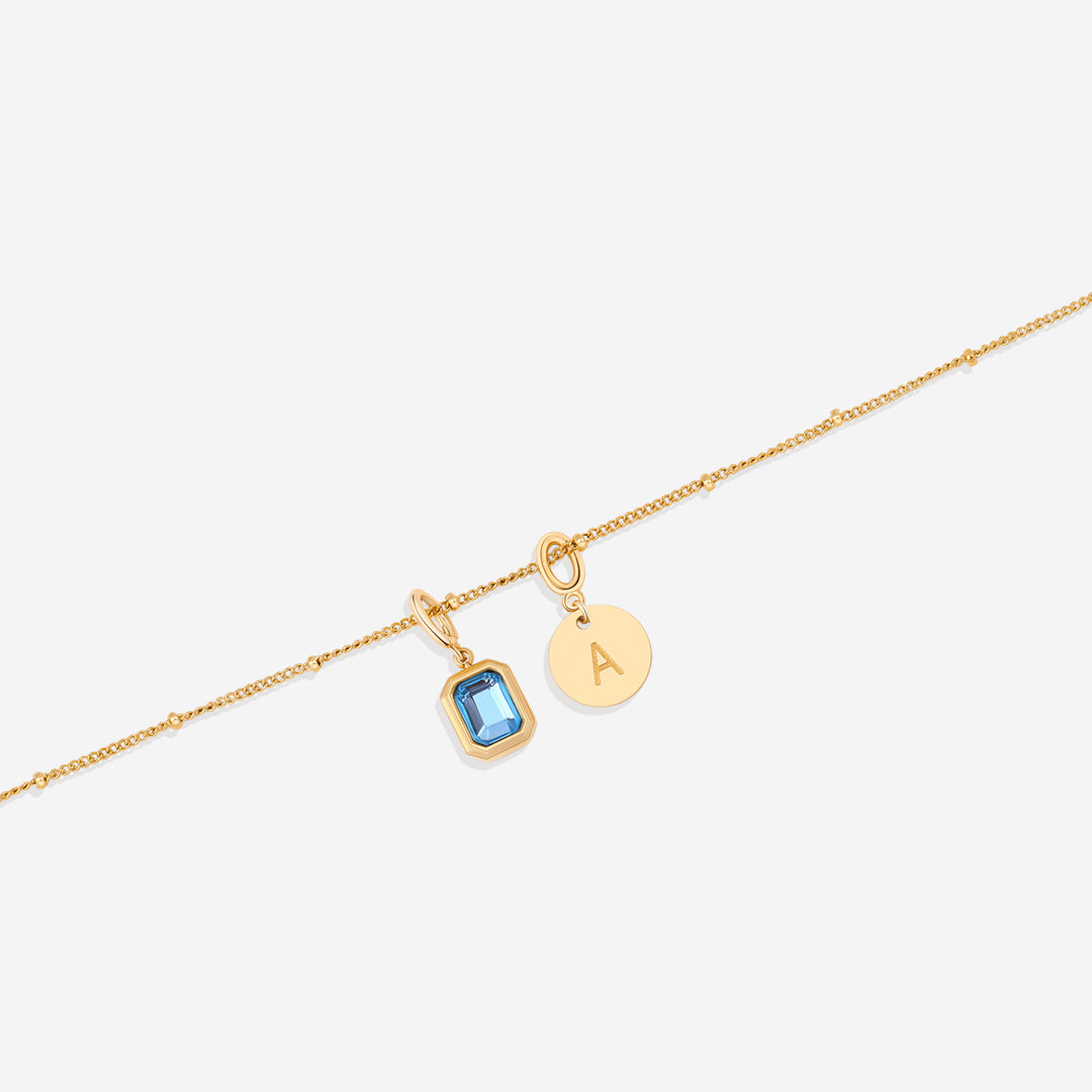 Collana con baguette, pietra portafortuna e iniziale