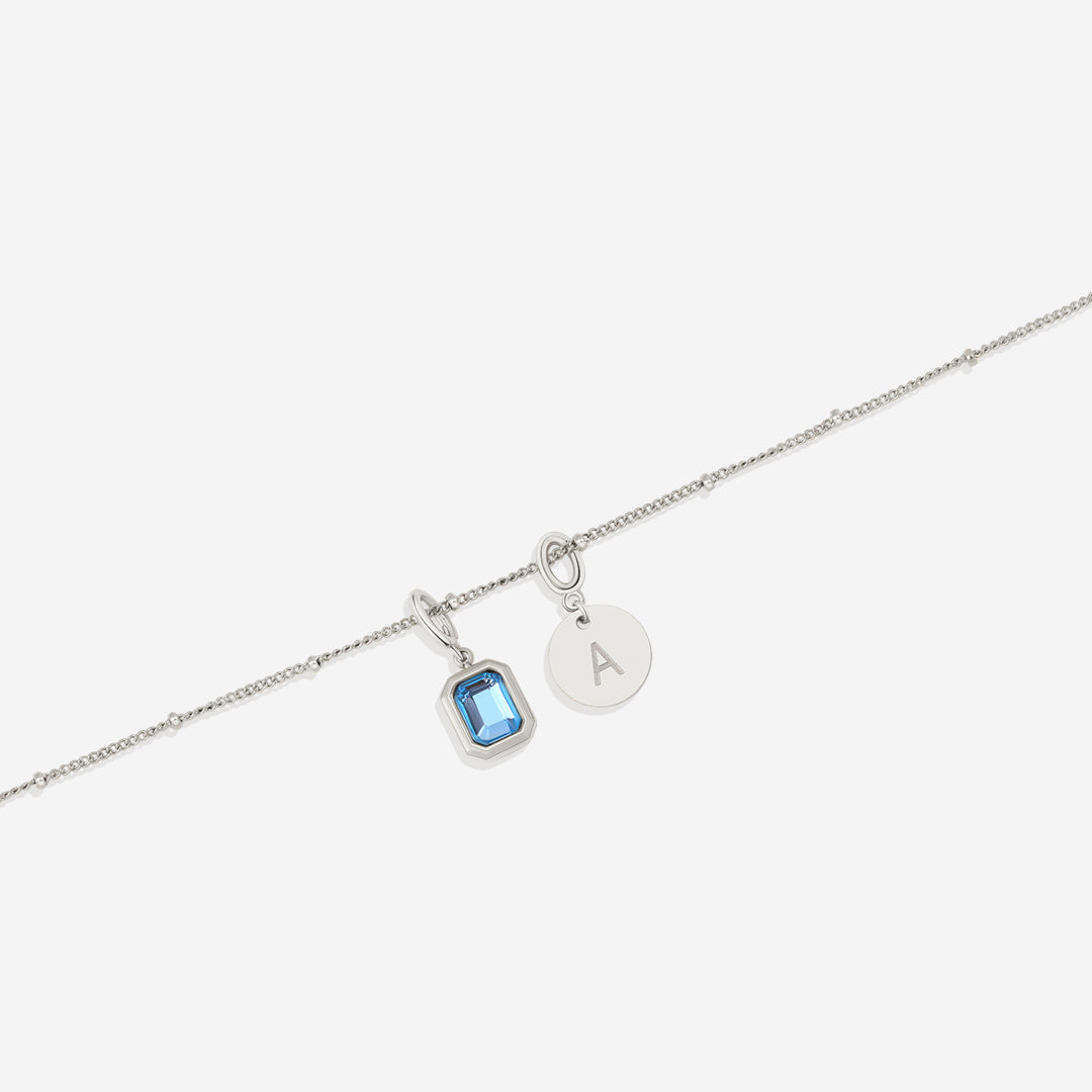 Collana con baguette, pietra portafortuna e iniziale