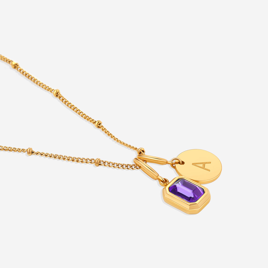 Collana con baguette, pietra portafortuna e iniziale