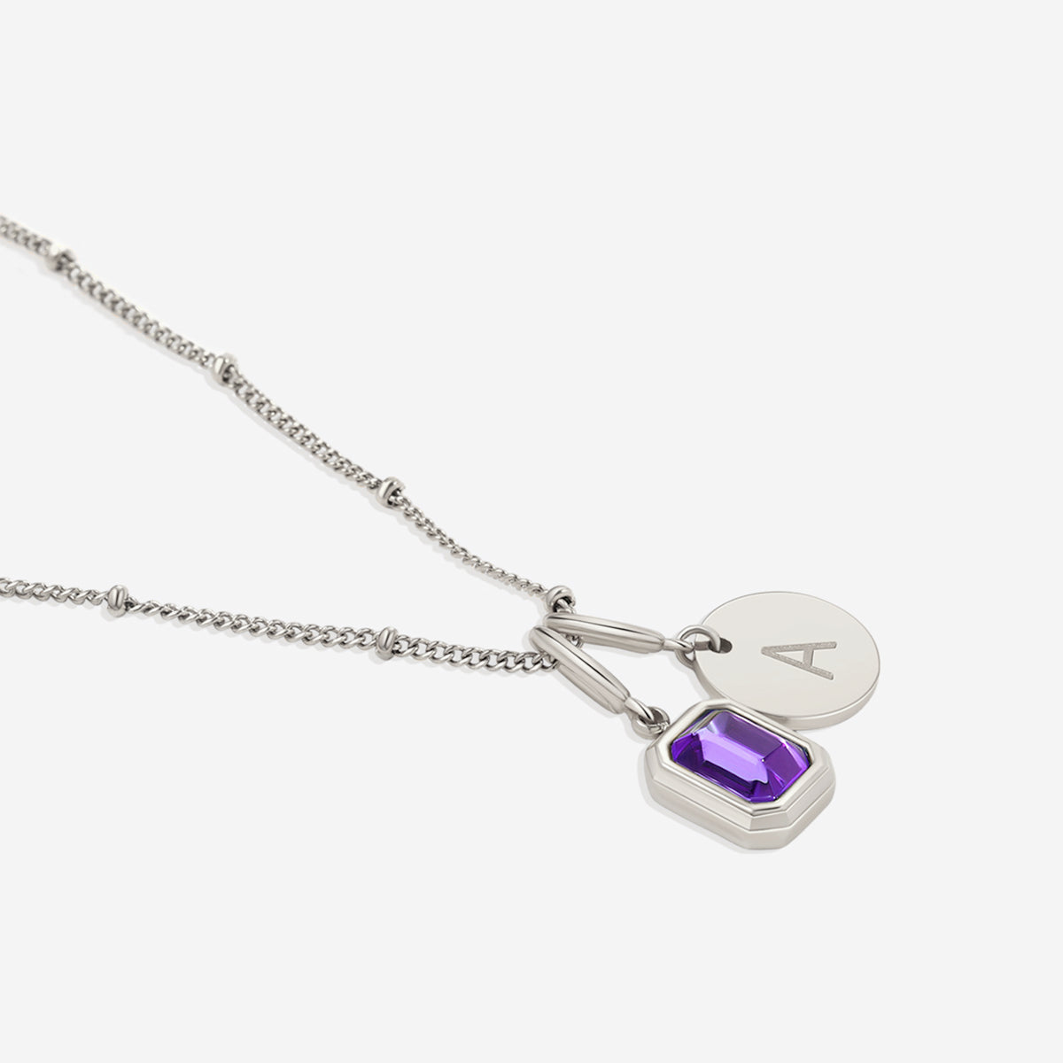 Collana con baguette, pietra portafortuna e iniziale