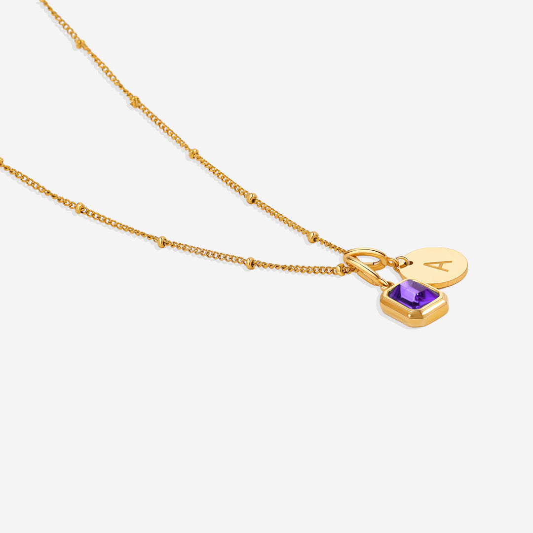 Collana con baguette, pietra portafortuna e iniziale