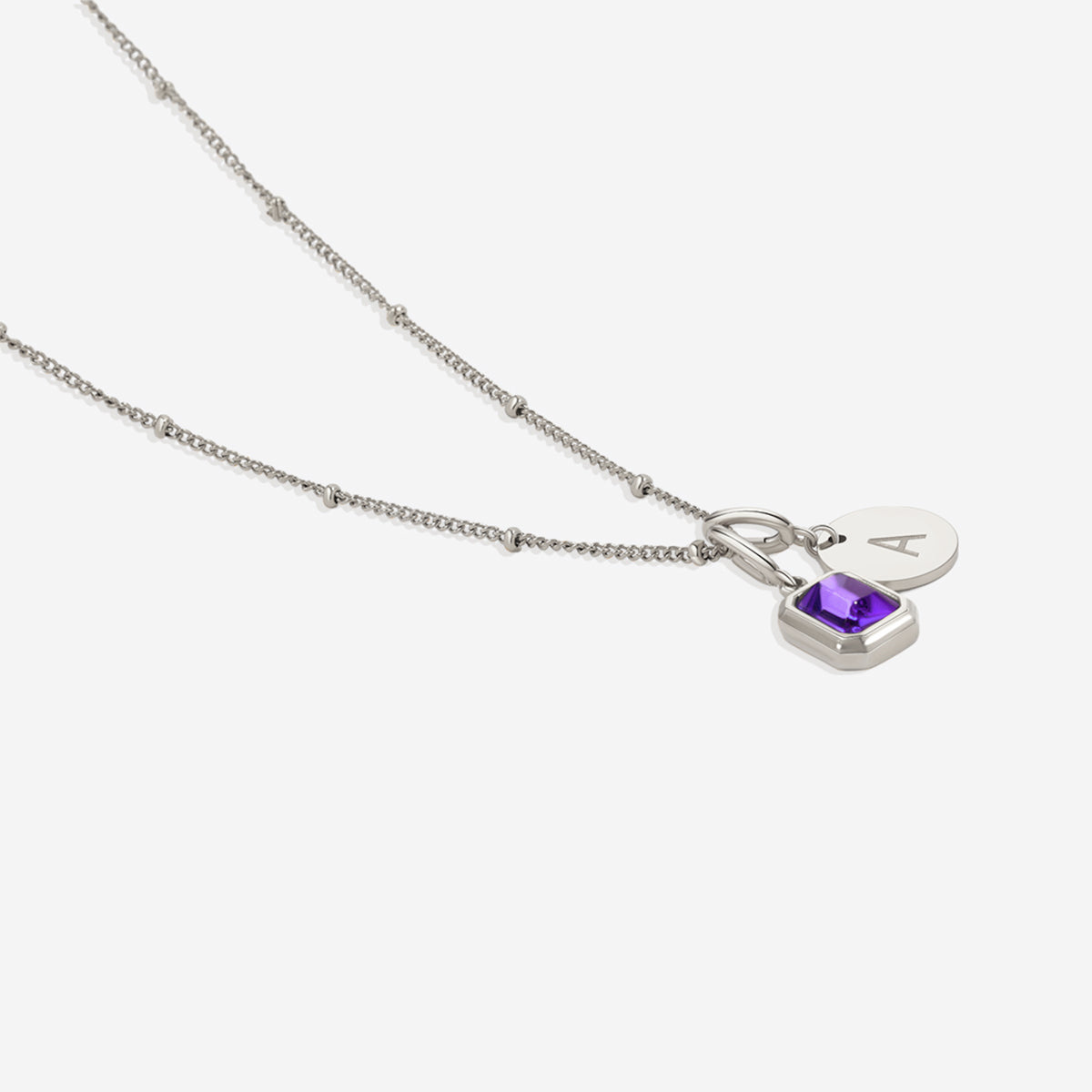Collana con baguette, pietra portafortuna e iniziale