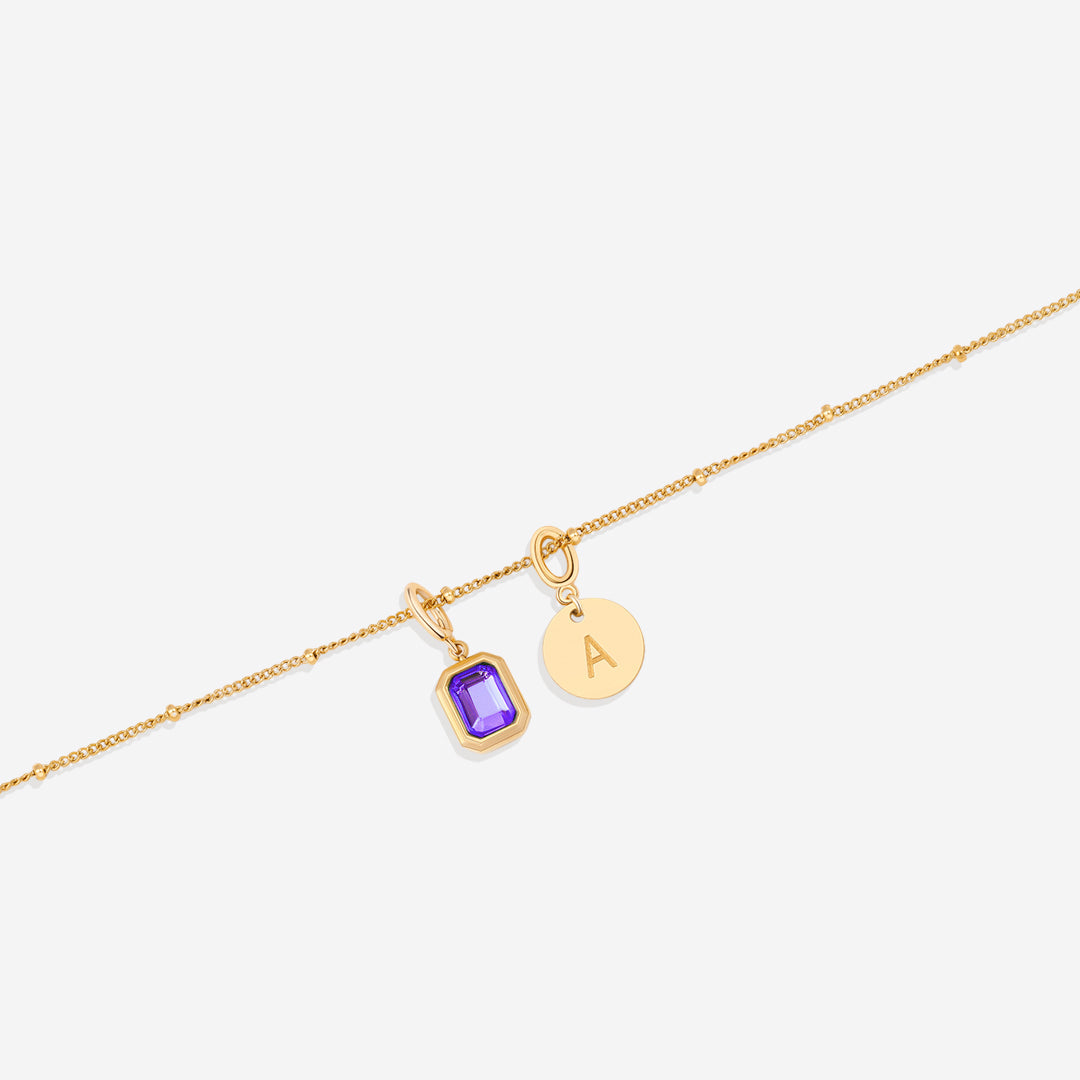 Collana con baguette, pietra portafortuna e iniziale