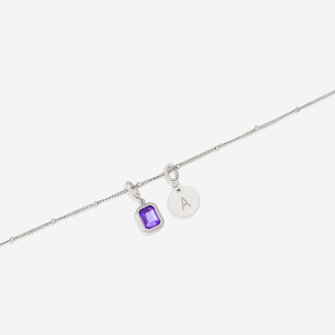 Collana con baguette, pietra portafortuna e iniziale