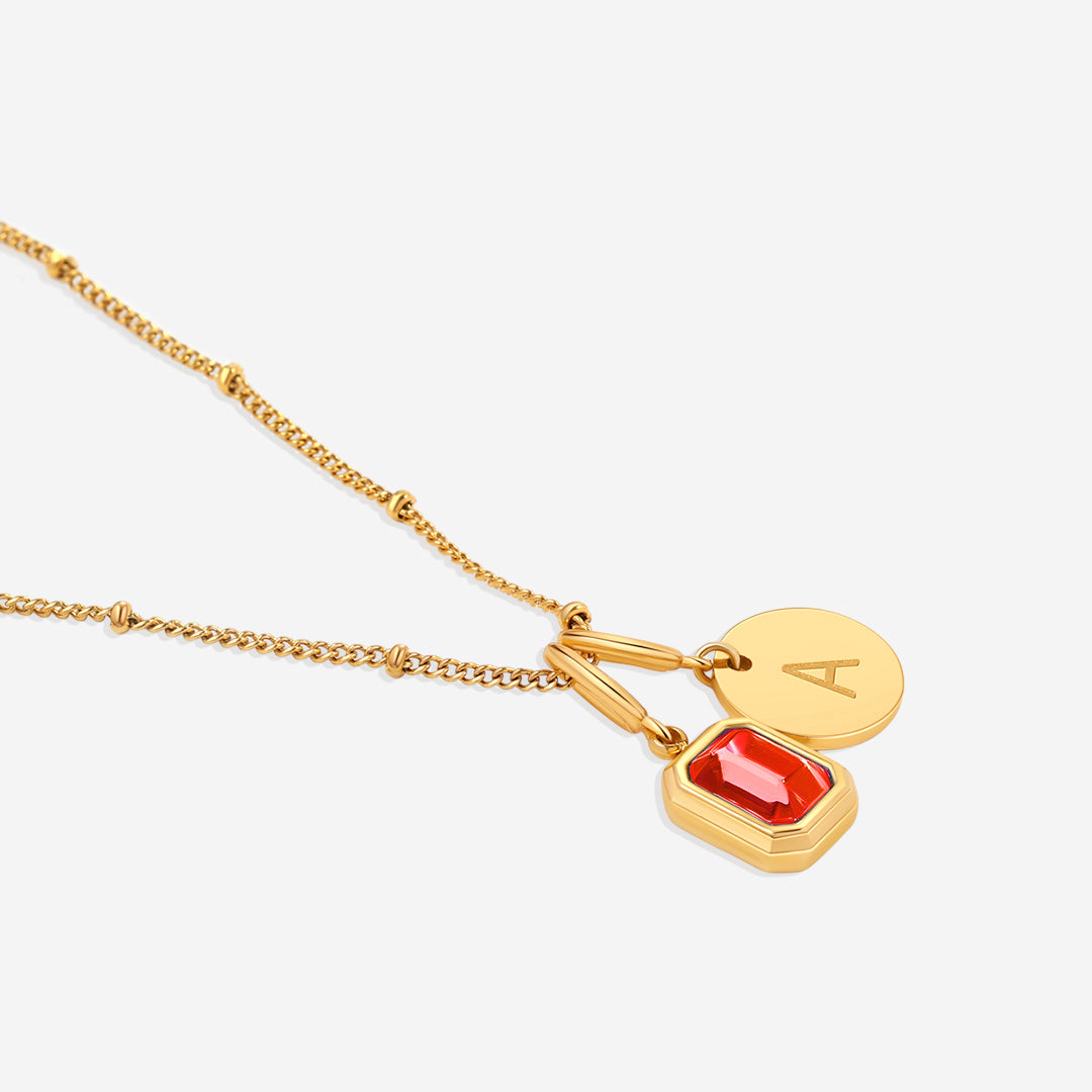 Collana con baguette, pietra portafortuna e iniziale