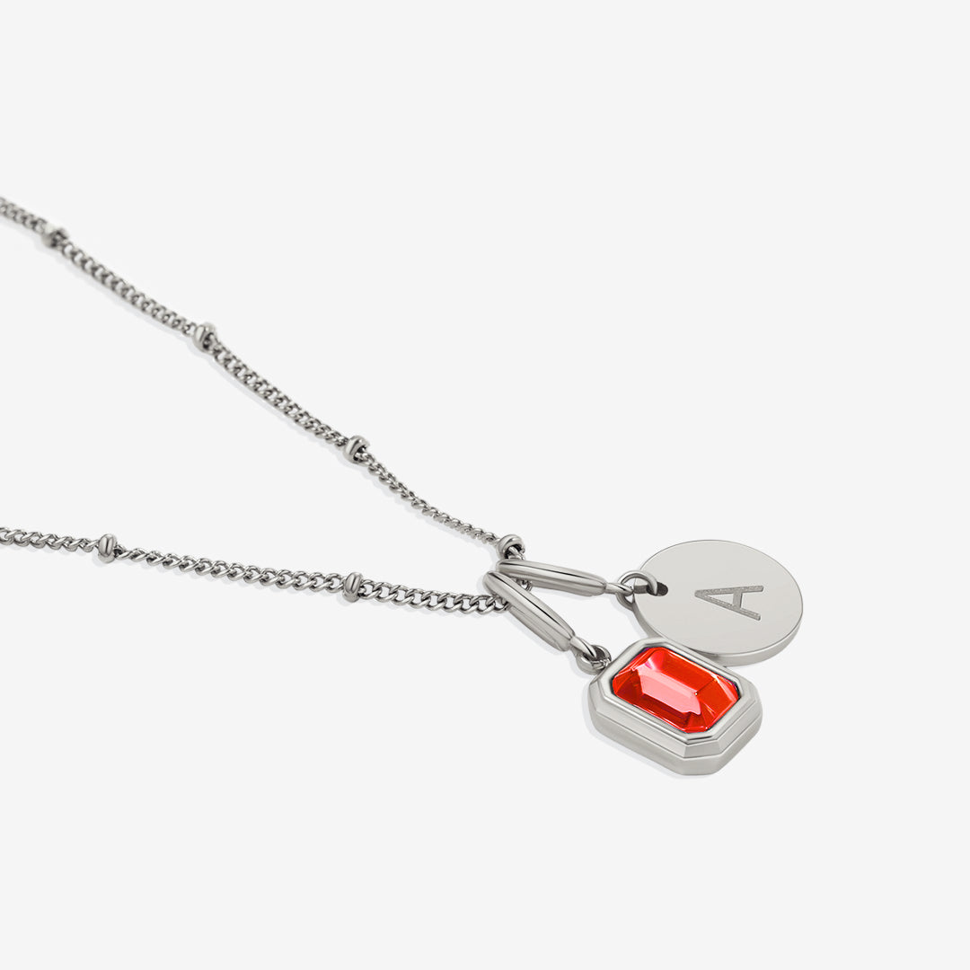 Collana con baguette, pietra portafortuna e iniziale