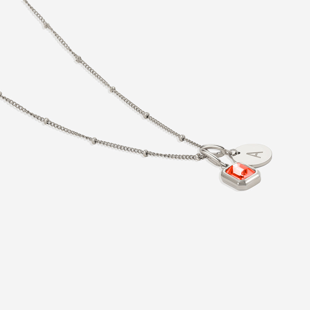 Collana con baguette, pietra portafortuna e iniziale