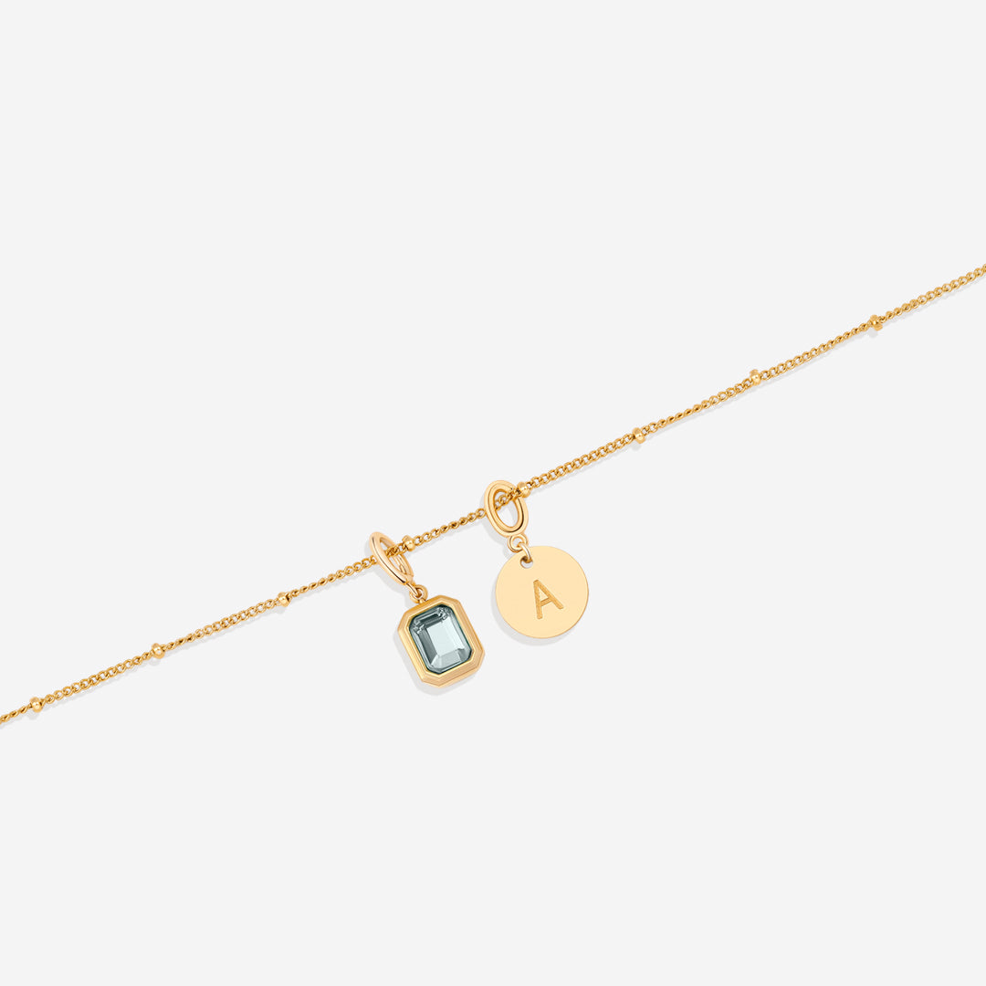 Collana con baguette, pietra portafortuna e iniziale