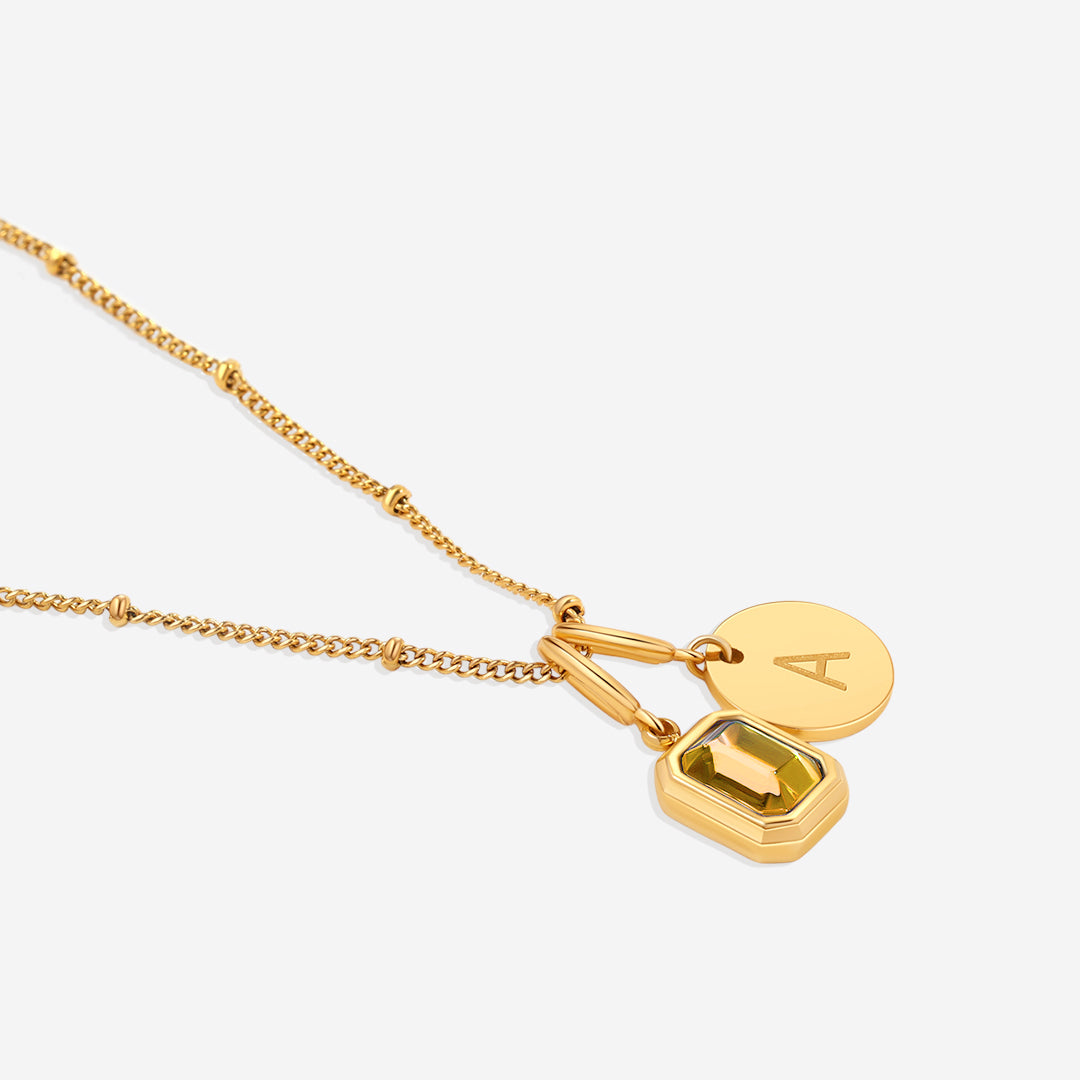 Collana con baguette, pietra portafortuna e iniziale