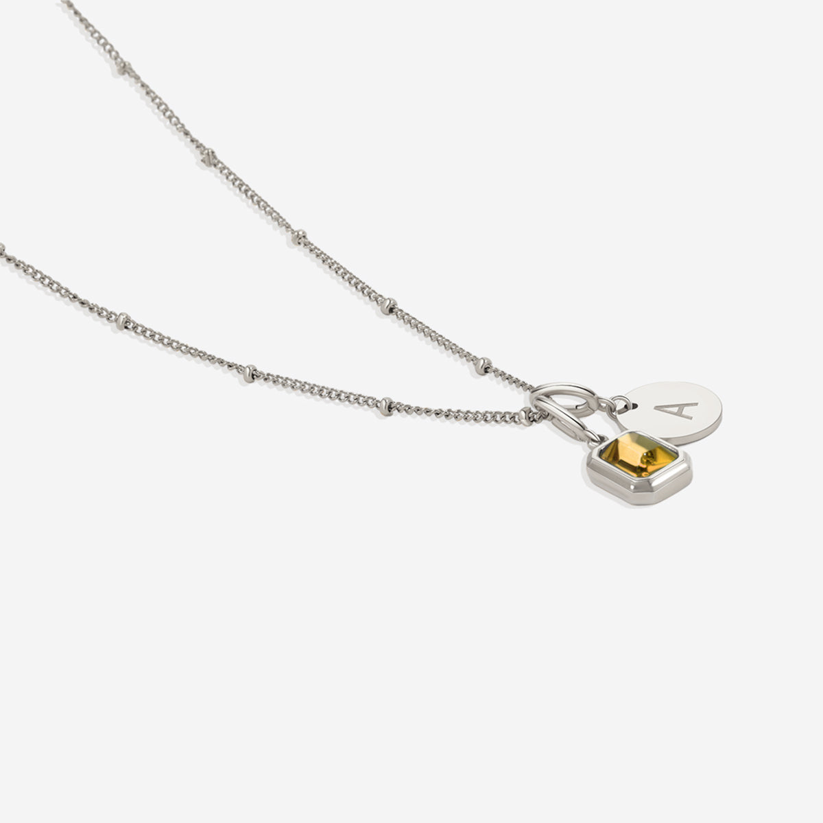 Collana con baguette, pietra portafortuna e iniziale