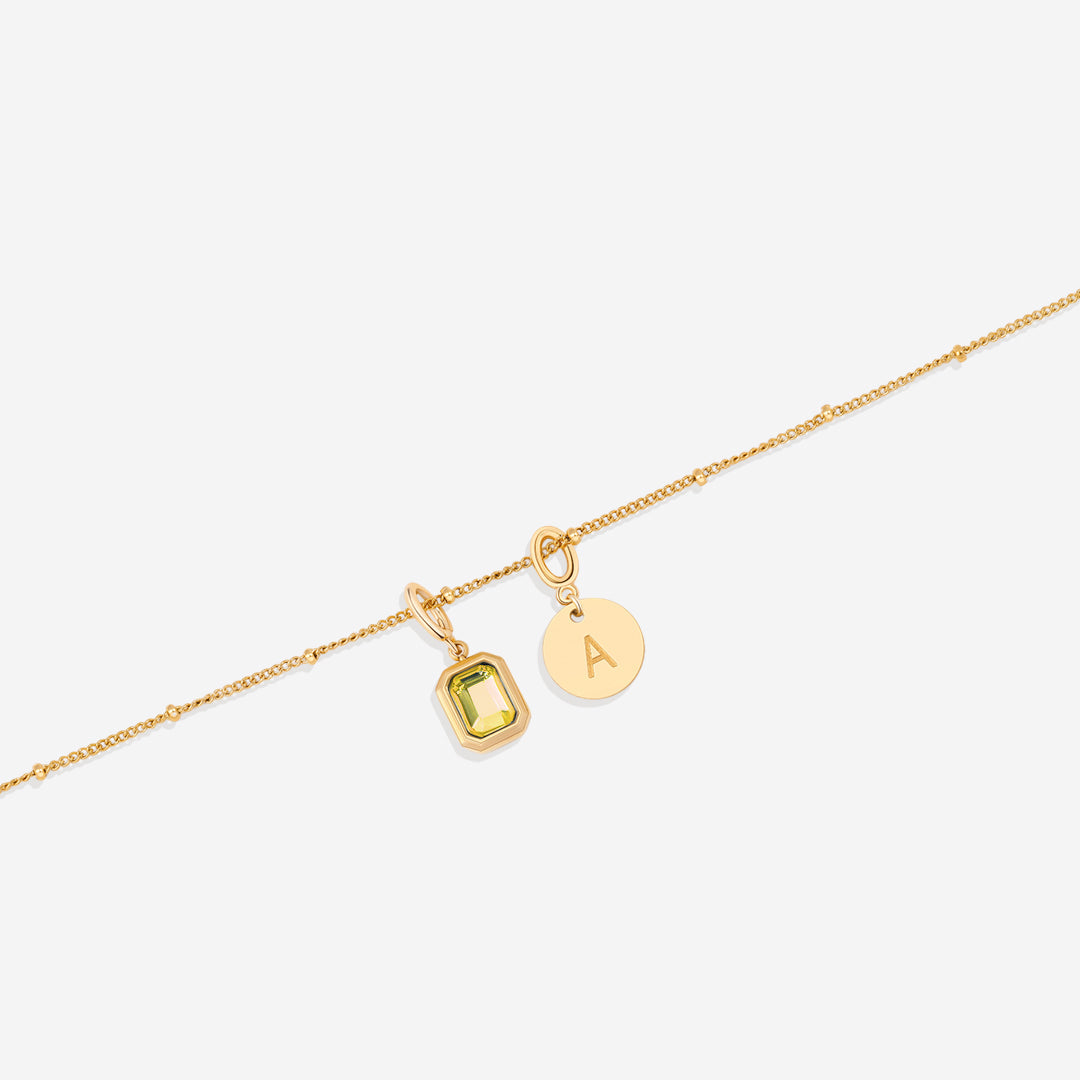 Collana con baguette, pietra portafortuna e iniziale