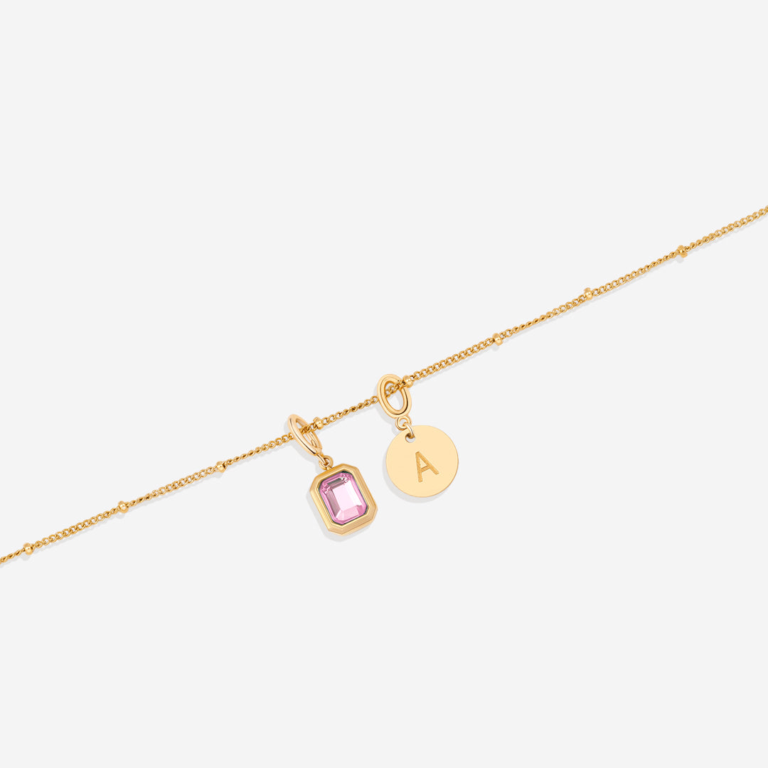 Collana con baguette, pietra portafortuna e iniziale