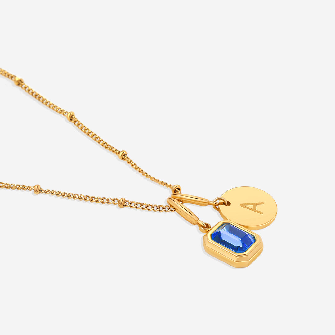 Collana con baguette, pietra portafortuna e iniziale