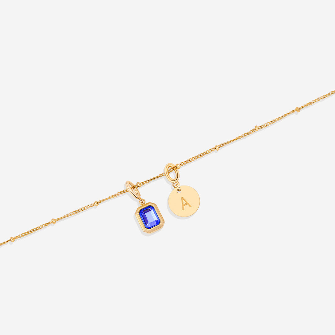 Collana con baguette, pietra portafortuna e iniziale