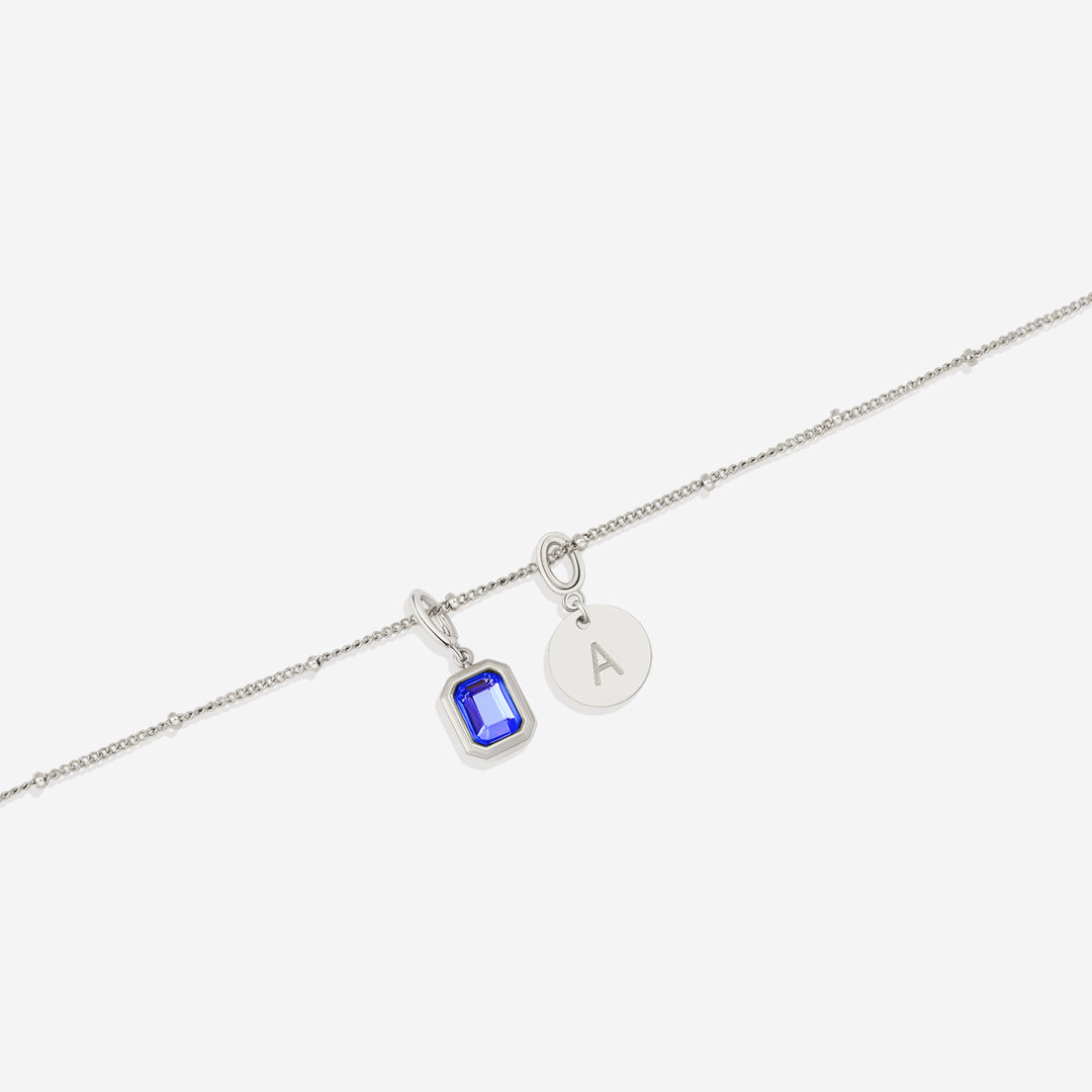 Collana con baguette, pietra portafortuna e iniziale