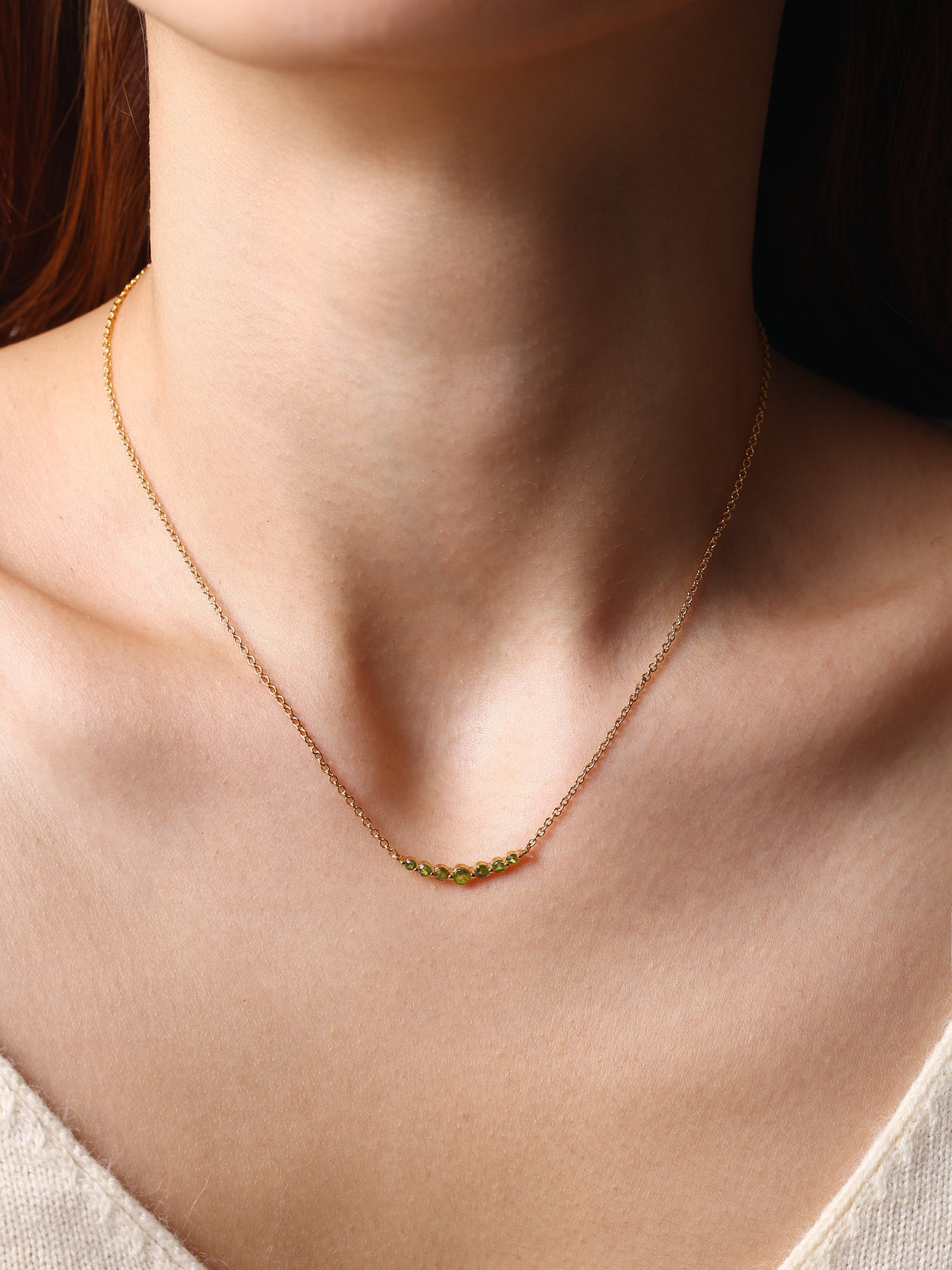 Birthstone Arc Necklace with August birthstone, worn on a model