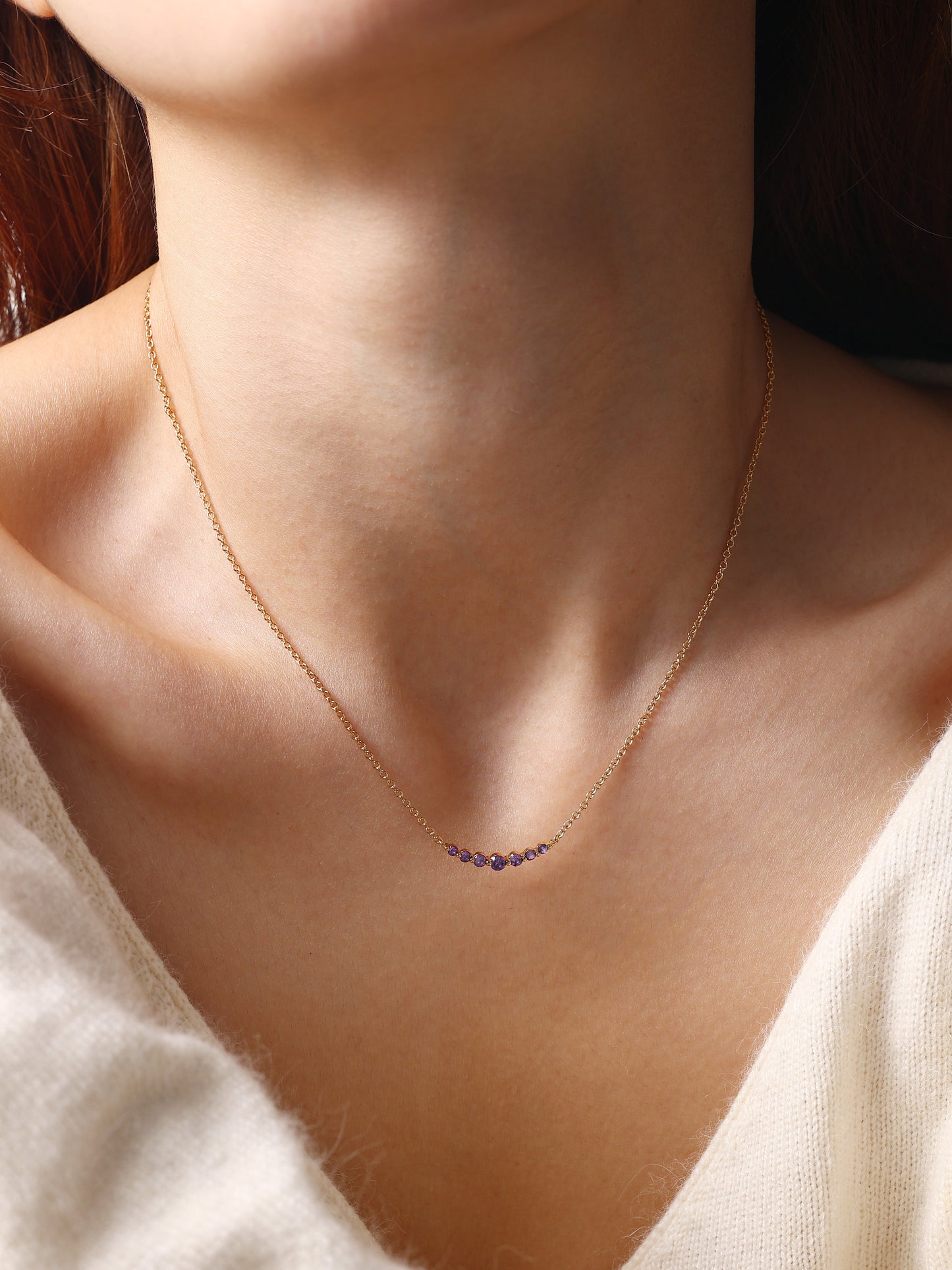 Birthstone Arc Necklace with February birthstone, worn on a model