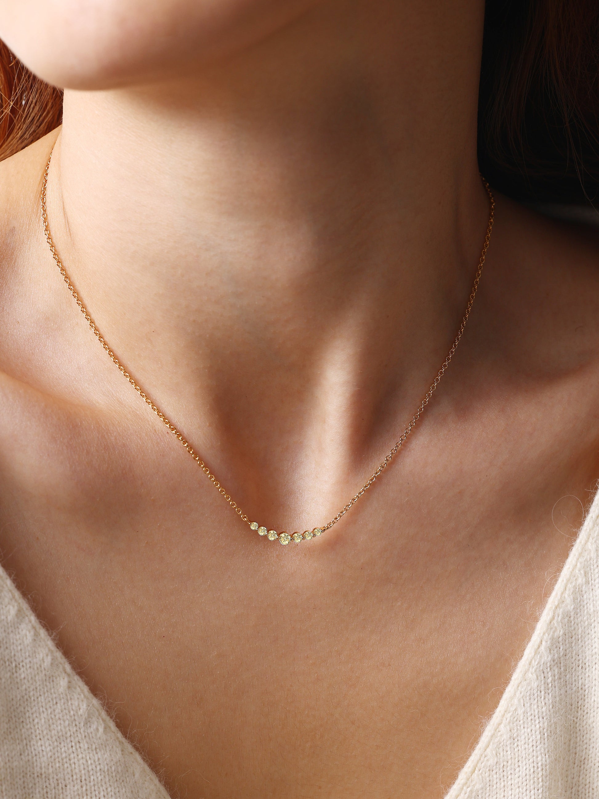 Birthstone Arc Necklace with November birthstone, worn on a model