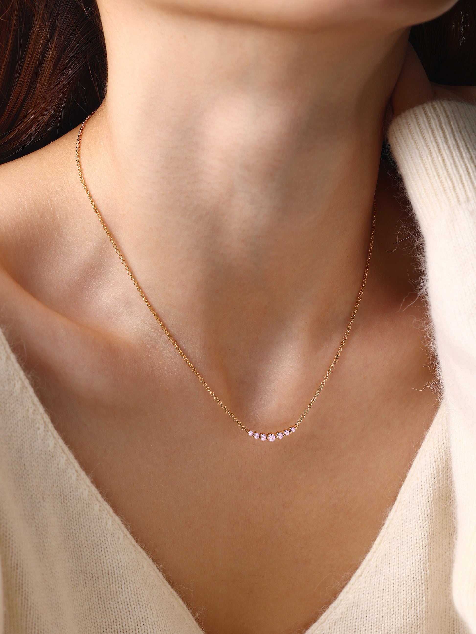 Birthstone Arc Necklace with October birthstone, worn on a model
