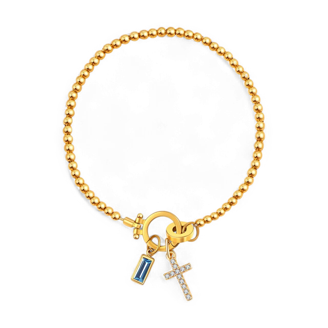 Cross Charm Birthstone Bracelet in gold tone with March birthstone