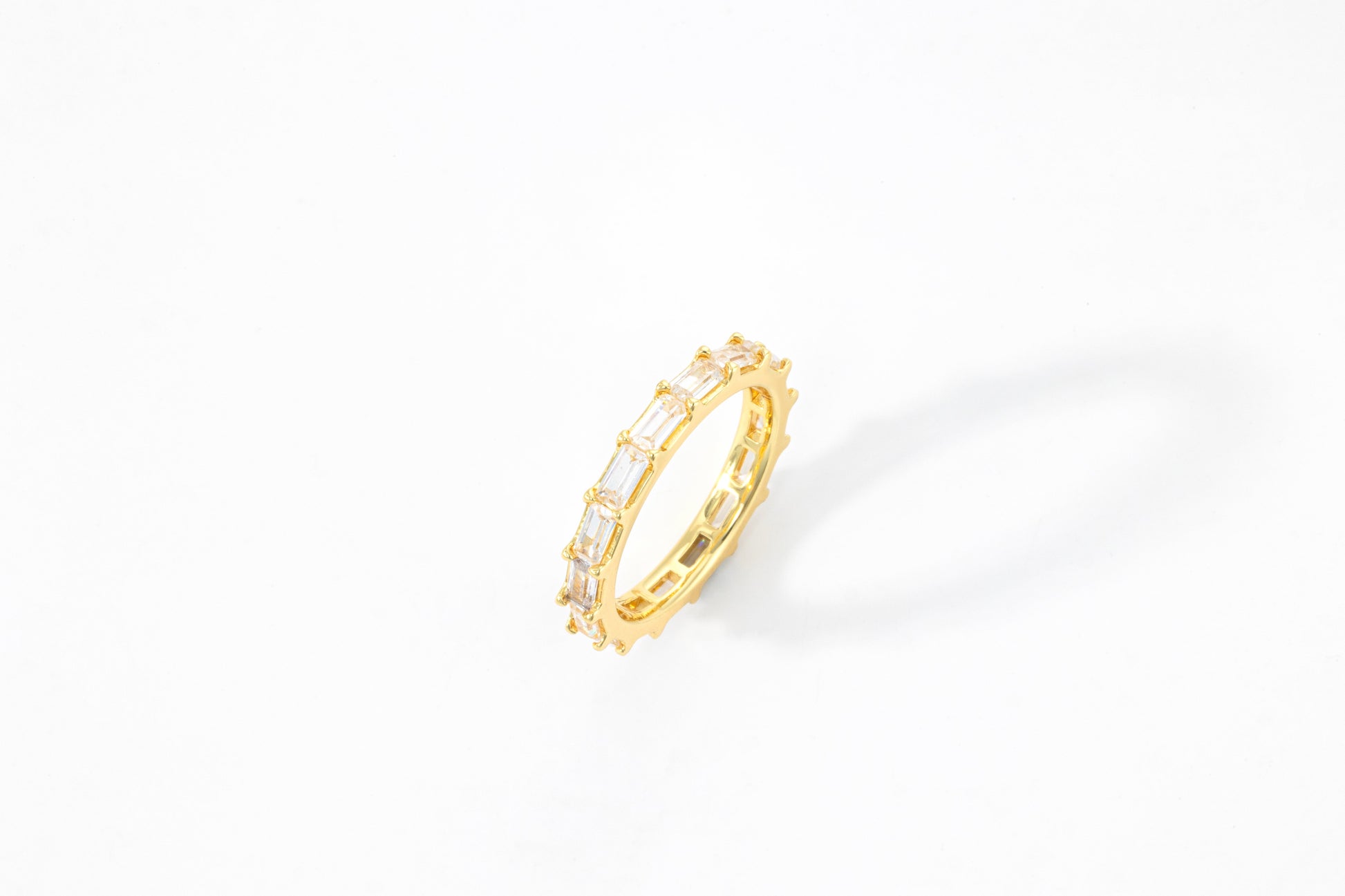 Emerald Eternity Band in gold tone, flat lay detail