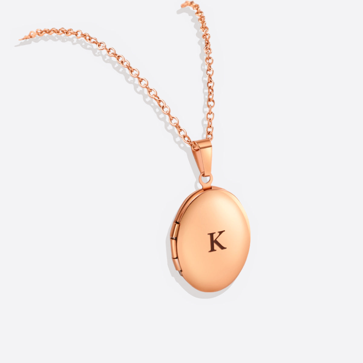 Engraved Oval Photo Locket Necklace in rose gold tone, flat lay detail