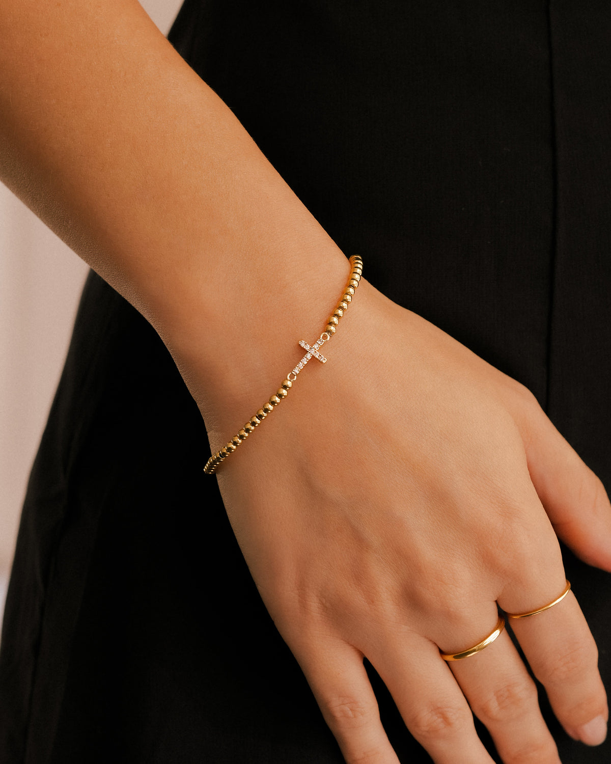 Gold Beaded Cross Stretch Bracelet, worn on a model