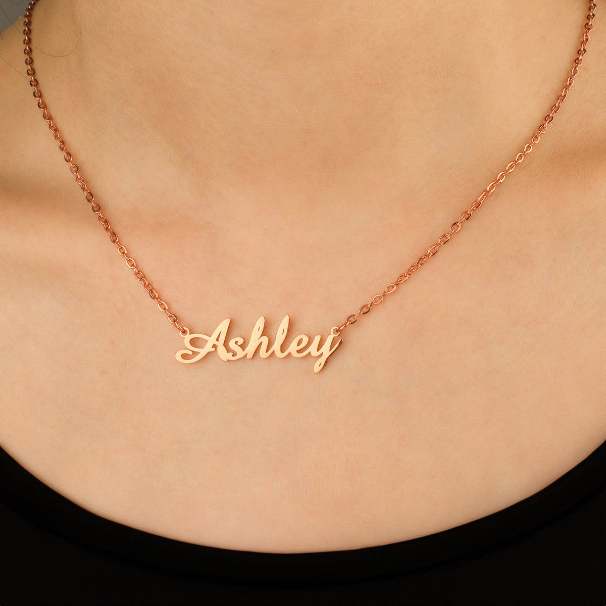 Quill Name Necklace in rose gold tone, worn on a model