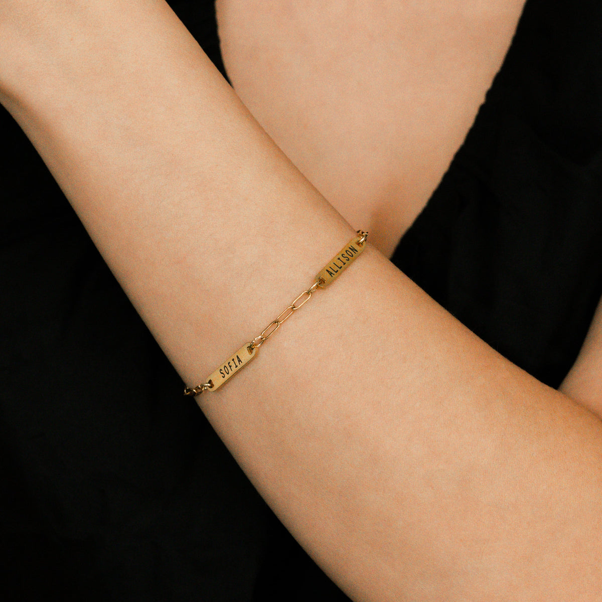 Personalized Paperclip Name Bracelet in gold tone, worn on a model