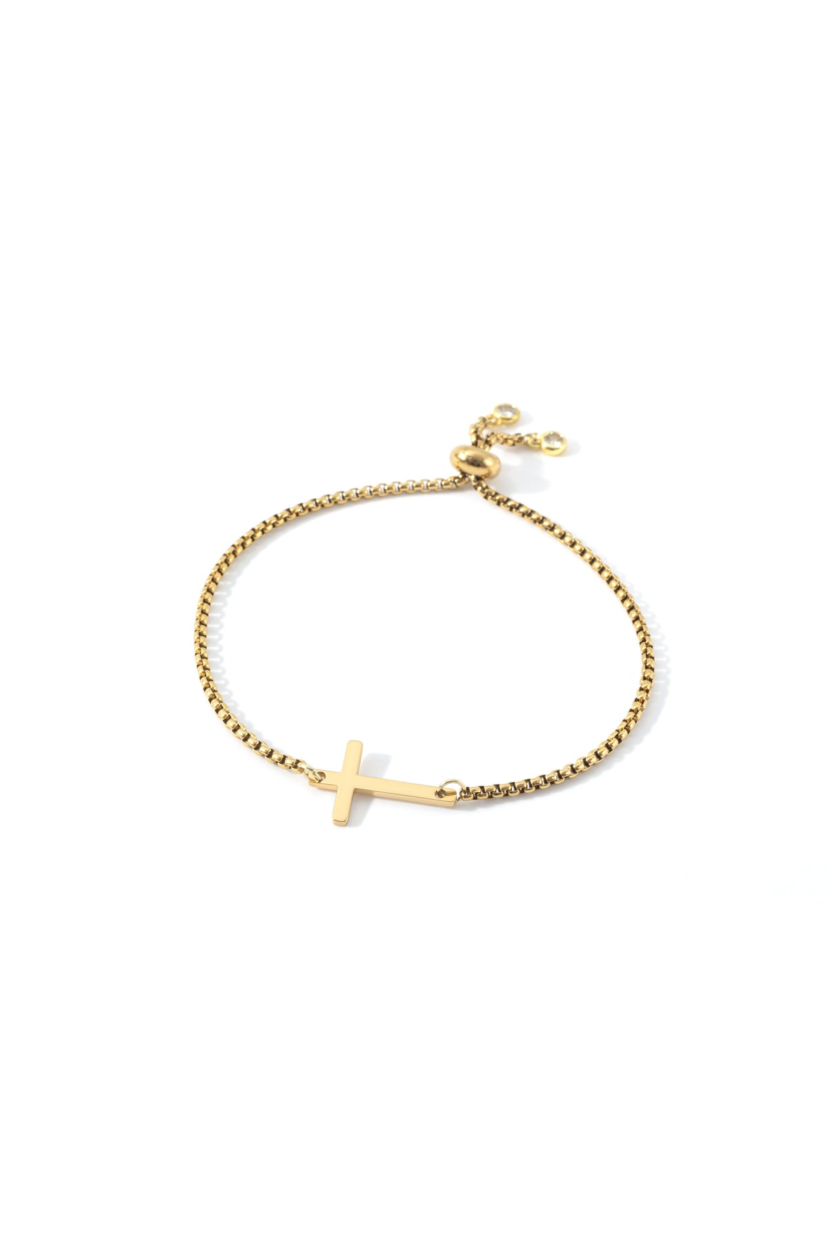 Sideways Cross Slider Bracelet in gold tone, flat lay detail