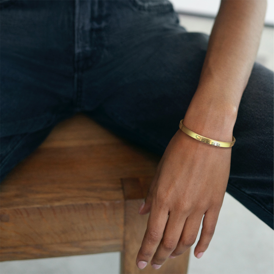 Mama Bear & Her Baby Bears Engraved Cuff Bracelet in gold tone, worn on a model