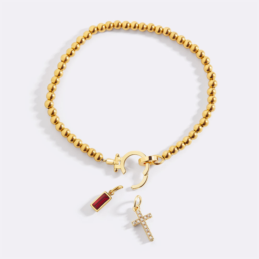 Cross Charm Birthstone Bracelet in gold tone