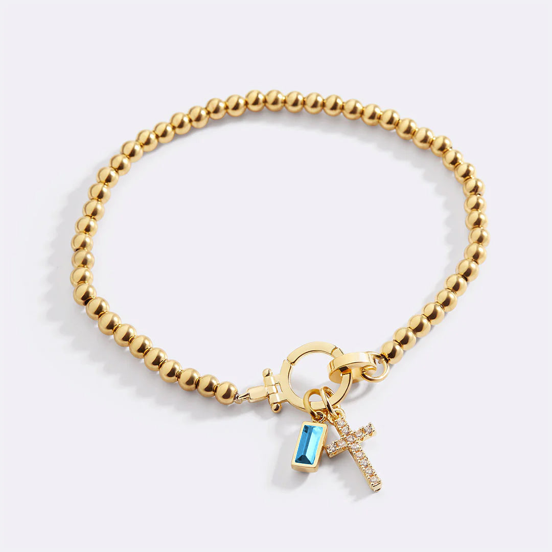 Cross Charm Birthstone Bracelet in gold tone with December birthstone