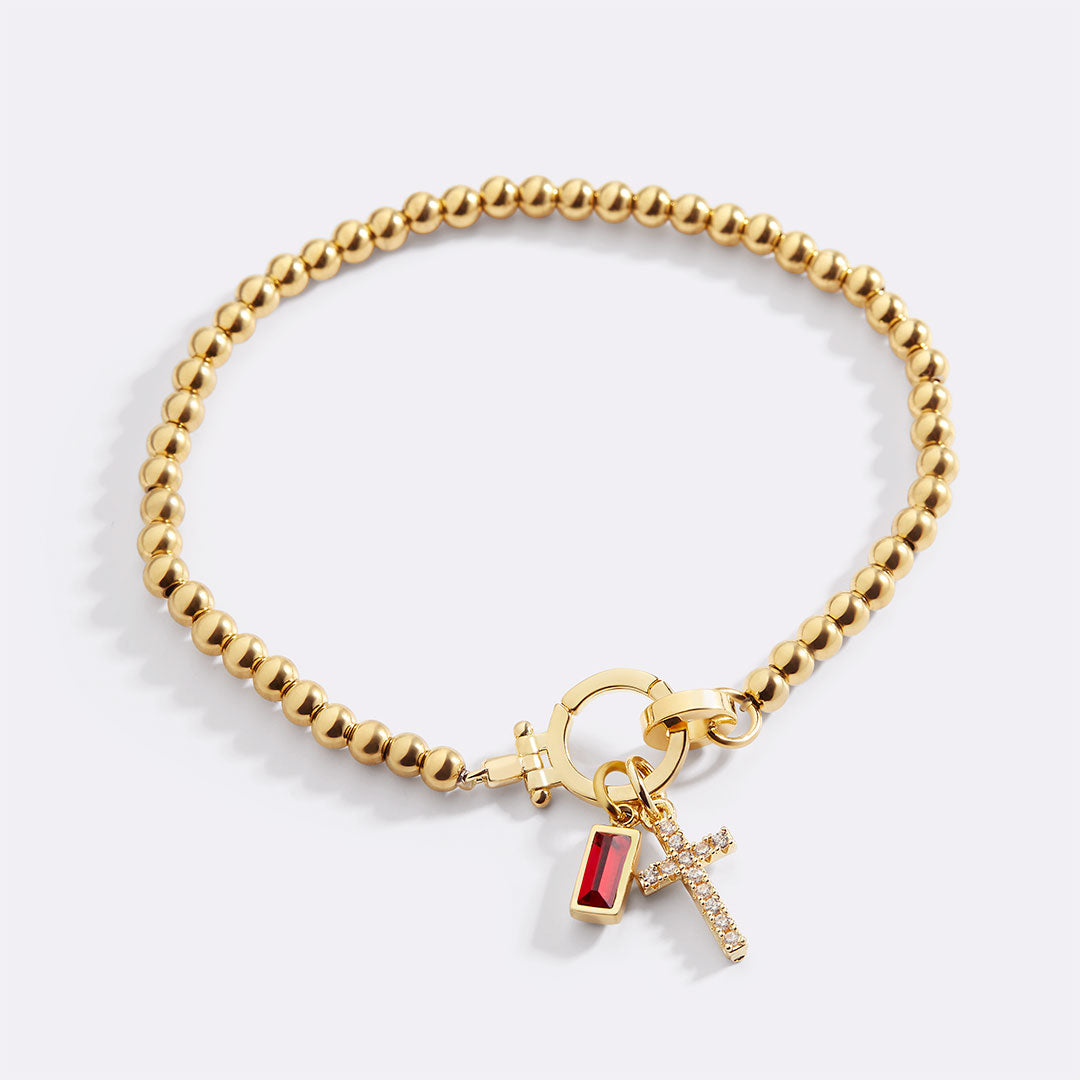 Cross Charm Birthstone Bracelet in gold tone with January birthstone