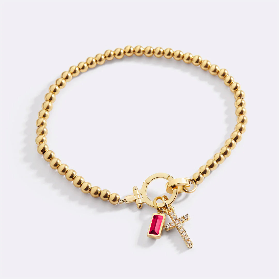 Cross Charm Birthstone Bracelet in gold tone with July birthstone