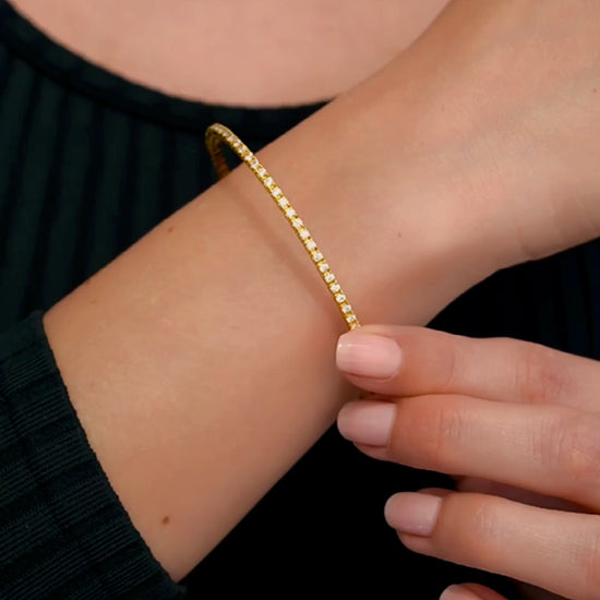 Gold bracelet with small gemstone accents